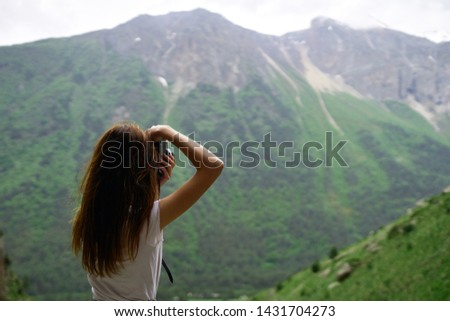 woman photographing a landscape on camera nature