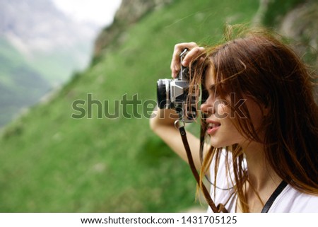 woman with camera snapshots nature summer mountains landscape