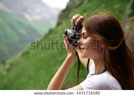 woman takes pictures of nature trip