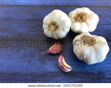 Raw organic garlic on wooden background. Food concept.