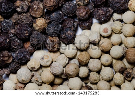 close up image of  black and white pepper