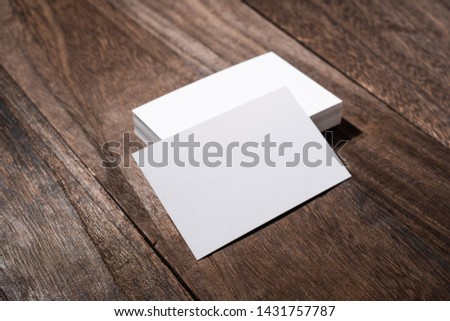 Design concept - perspective view of white business card on wood floor background for mockup