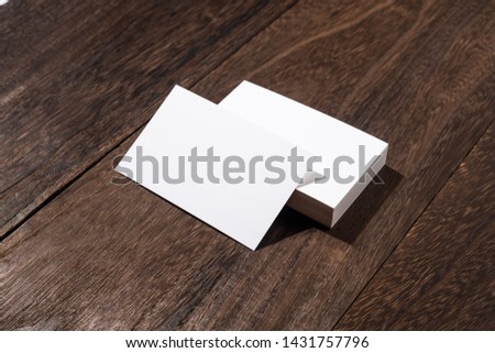 Design concept - perspective view of white business card on wood floor background for mockup
