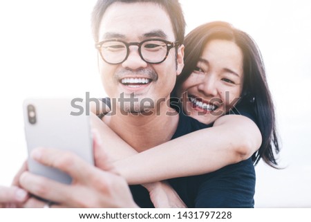 couple love concept.asian lover man and women taking a selfie while travelling on holiday hug each other.photo of people smile enjoy  Beautiful romantic time
