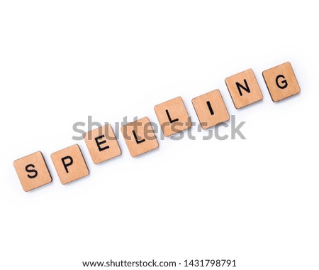 The word SPELLING, spelt with wooden letter tiles over a white background.