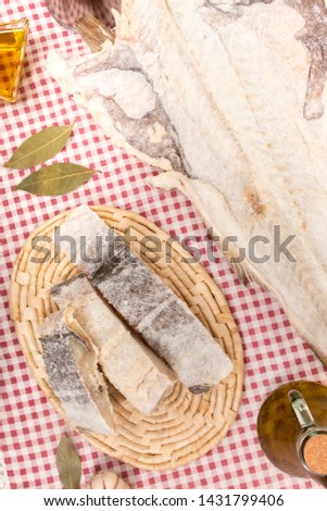 Close up view of a portuguese salted codfish on a table cloth.