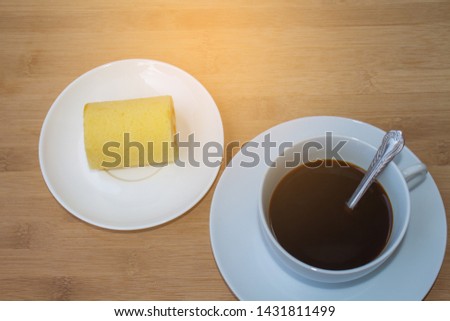 Black coffee in a white cup with bread, brake food