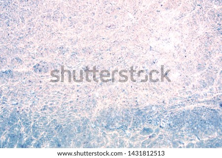 Abstract of colorful stone with small ripple wave on stone beach background.