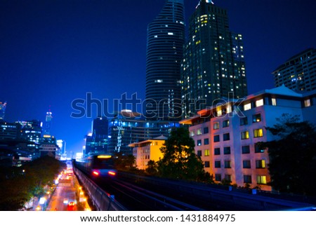 Cityscape of BTS Ratchadamri station at night in Bangkok city