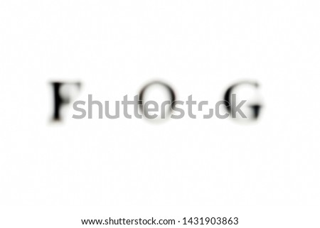 The inscription FOG. FOG in black blurred letters on a white background. Photo of the lettering, close-up
