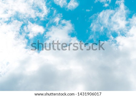Air and fluffy clouds in the blue sky on a sunny day, background texture