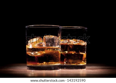Whiskey drinks on wooden table