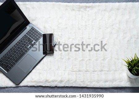 Laptop on white bed work at home concept. Background image.