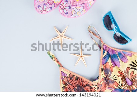 summer fashion concept with various stuff on blue background