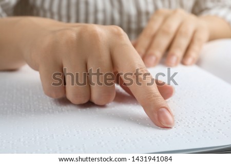 Blind person reading book written in Braille, closeup