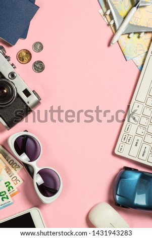 Trip planning background. Old film camera, map, cash money, map and airplane on pink background. Top view. Flat lay.