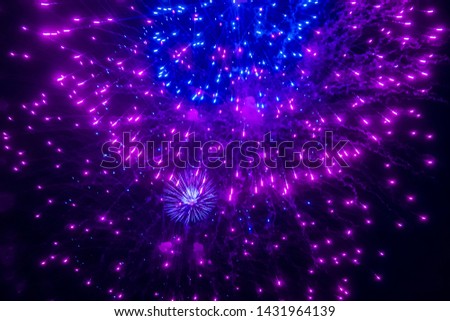 Neon firework lights in the night sky. Can be used as an abstract background.
