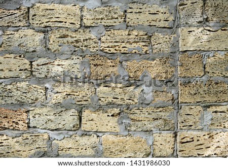 brick wall of large stone blocks fastened with gray cement, copy space