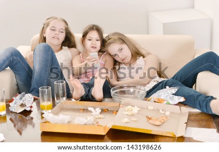 Three cheerful girls relaxing at home together
