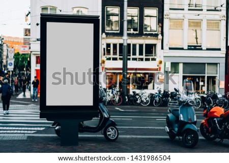 Clear Billboard on city street with blank copy space screen for advertising or promotional poster content,empty mockup Lightbox for information,blank display outdoors in urban area with people walking