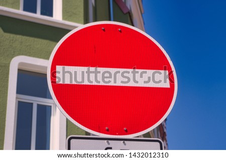 One way street sign in Germany with a deep blue sky and a blurred building in the background