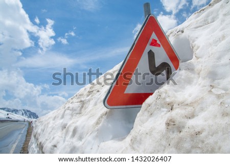 Signpost almost buried in the snow, Italian Alps, altitude 2200 