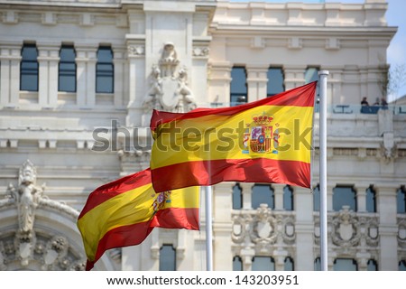 Flag of Spain in the wind in front of Palace of Communication (Spanish: Palacio de Comunicaciones) in Madrid, Spain Royalty-Free Stock Photo #143203951
