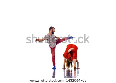 The two young modern ballet dancing over white studio background