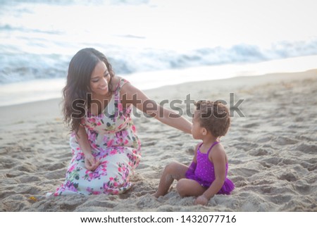 Mother and her little girl on the beach
