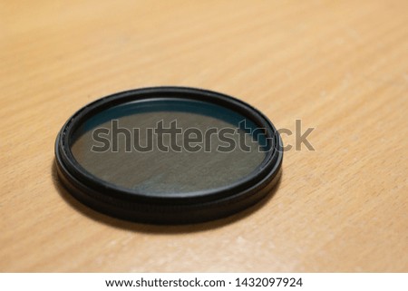 Dirty Photo filter isolated on wooden table 