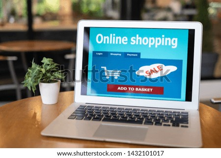 Online shopping web pages are displayed on the laptop screen. Business and modern lifestyle concept.