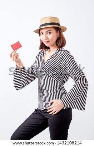 Closeup fashion studio portrait of asian young woman business smiling the hand holding credit card with hat white wall background