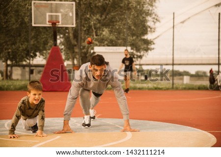 
Father and son on basketball court