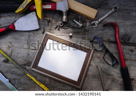 wooden frame on the wall. construction worker with drill. hammer and tools on wood planks with copy space