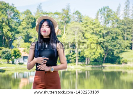 Portrait of asian women relax with green nature backgound, Rest on vacation with nature forest, Smilling and chilling girl