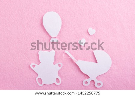 cartoon styled baby carriage on pink background