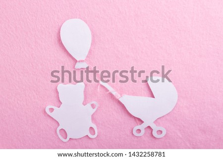 cartoon styled baby carriage on pink background