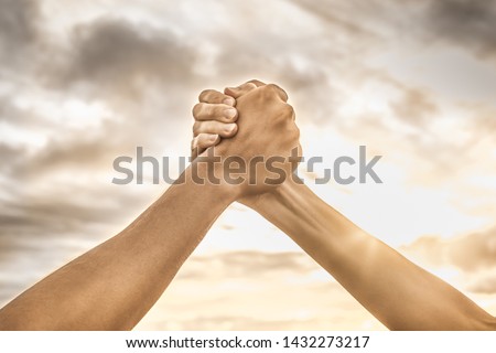 Strong hands coming together grasping one another, helping hand. People working together, unity, teamwork  Royalty-Free Stock Photo #1432273217