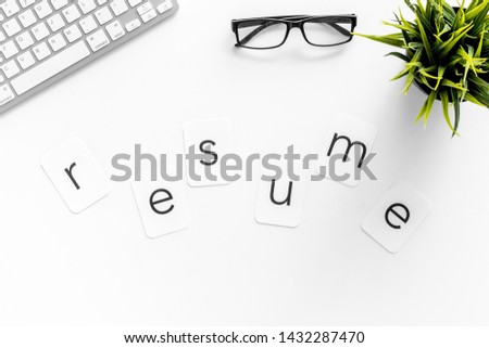 Resume copy on work place with keyboard and glass on white desk background top view