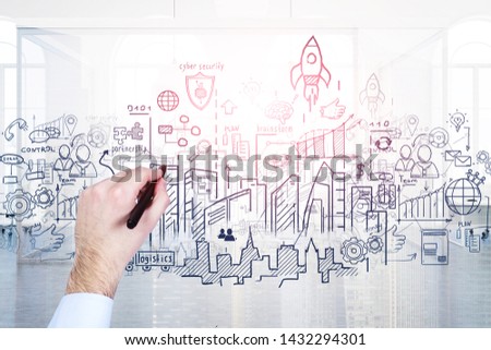 Hand of businessman drawing start up sketch with marker over office and city background. Toned image double exposure