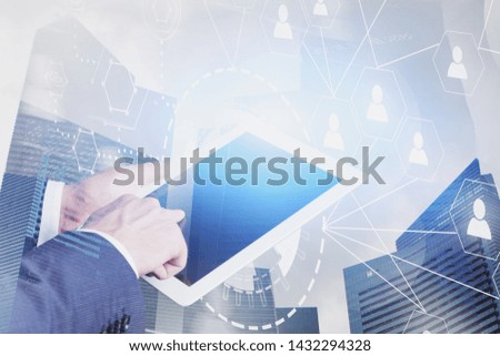 Hands of businessman working with tablet computer over city background with double exposure of social network HUD interface. Concept of HR and hi tech. Toned image