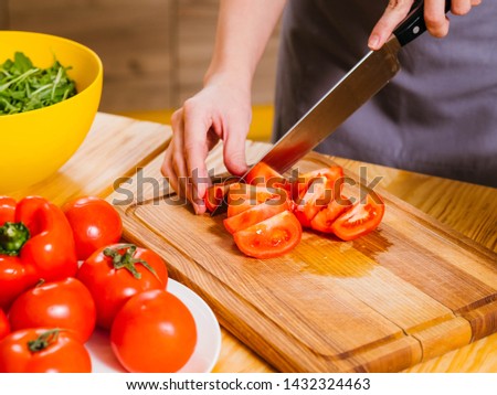 Healthy nutrition. Cropped shot of woman cooking, chopping tomatoes for salad.