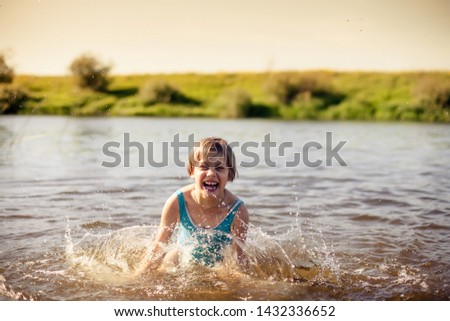 Girl bathing in   river on   summer day. 