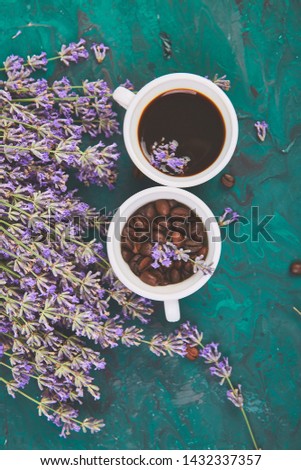 Coffee, coffee grain in cups and lavender flower on green background from above. Good Morning concept. Woman working desk. Cozy breakfast. Mockup. Flat lay style