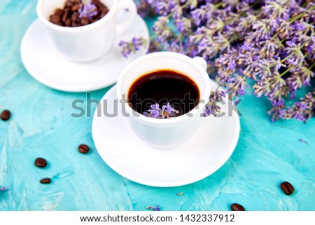 Coffee and lavender flower on blue background from above. Good Morning concept. Woman working desk. Cozy breakfast. Mockup. Flat lay style