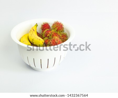 Fresh Thai fruit in the white basket on the isolated white background
