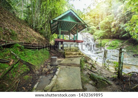 Bamboo Forest With Path to Traditional Zen Garden Rest House Beside Waterfall