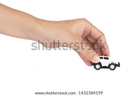 Hand holding Police Car Toys isolated on a white background.