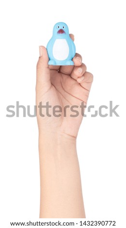 hand holding Plastic Toy Animal isolated on white background