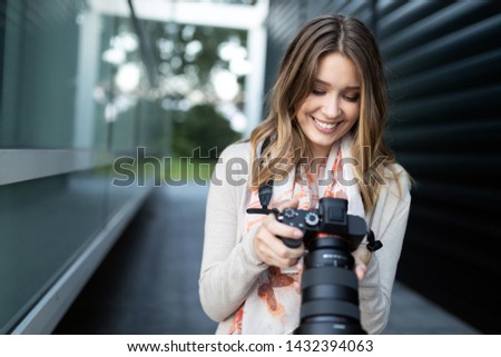 Woman is a professional photographer with dslr camera